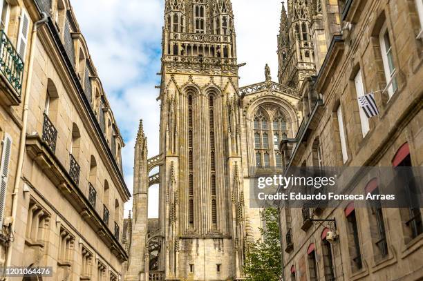 view of classical stone houses with the saint corentin cathedral on the background - quimper stockfoto's en -beelden
