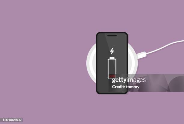 ilustrações de stock, clip art, desenhos animados e ícones de the mobile phone has a low battery on a wireless charger - abastecer