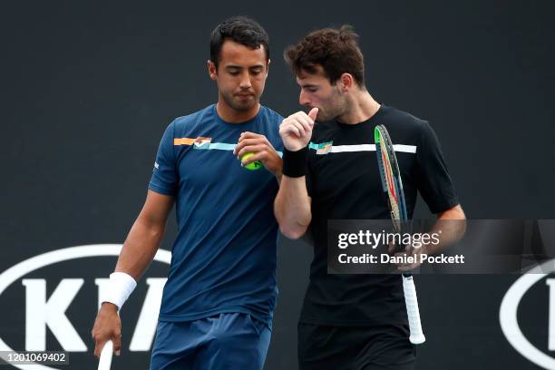 Hugo Dellien of Bolivia and Juan Ignacio Londero of Argentina talk tactics during their Men's Doubles first round match against Marcelo Arevalo of El...