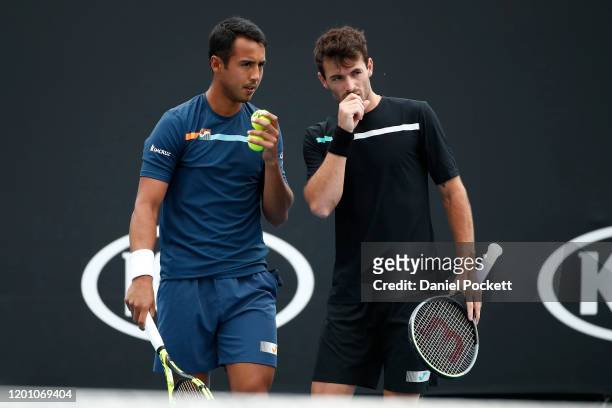 Hugo Dellien of Bolivia and Juan Ignacio Londero of Argentina talk tactics during their Men's Doubles first round match against Marcelo Arevalo of El...