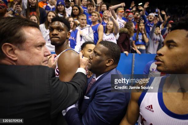 Head coach Bill Self of the Kansas Jayhawks holds back Silvio De Sousa of the Kansas Jayhawks during a brawl as the game against the Kansas State...