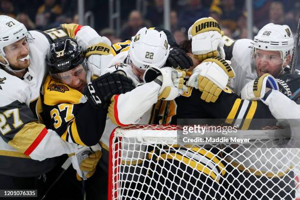 Paul Stastny, Nick Holden, and Shea Theodore of the Vegas Golden Knights fight Patrice Bergeron of the Boston Bruins and Brad Marchand during the...