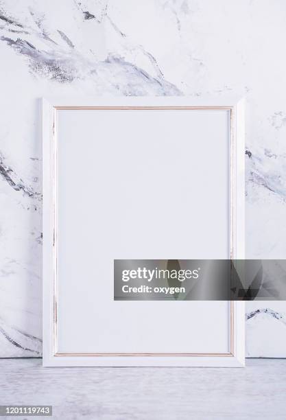 blank white picture paper frame poster on gray marble table at concrete wall, template mock up for adding your design baclground - blank book on desk photos et images de collection