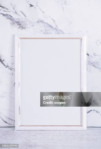 blank white picture paper frame poster on gray marble table at concrete wall, template mock up for adding your design baclground - bulletin board border stock pictures, royalty-free photos & images