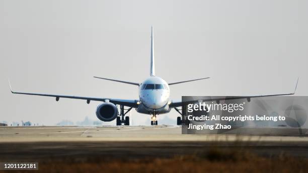front view of different types of aircrafts moving on runway - taxiing stock pictures, royalty-free photos & images