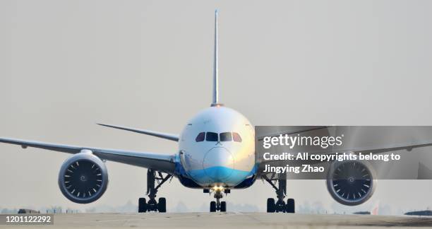 front view of different types of aircrafts moving on runway - airplane front view stock pictures, royalty-free photos & images