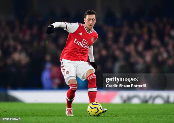 Mesut Ozil of Arsenal passes the ball during the Premier League match between Chelsea FC and Arsenal FC at Stamford Bridge on January 21, 2020 in...