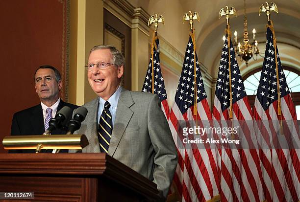 Senate Minority Leader Sen. Mitch McConnell speaks as Speaker of the House Rep. John Boehner looks on during a news conference on the debt ceiling...