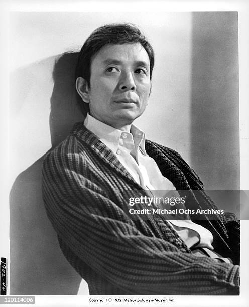 James Hong leaning against the wall in a scene from the film 'The Carey Treatment', 1972.