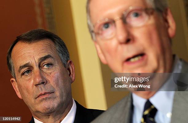 Senate Minority Leader Sen. Mitch McConnell speaks as Speaker of the House Rep. John Boehner looks on during a news conference on the debt ceiling...