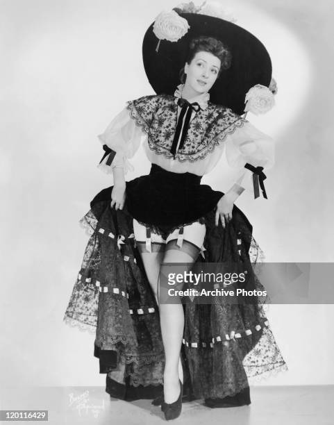 American actress and burlesque entertainer Gypsy Rose Lee in a wide-brimmed hat, lace skirt and top with matching trim, circa 1945.