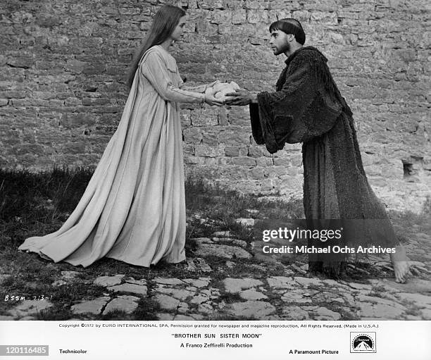 Judi Bowker offers a loaf of bread to Graham Faulkner in a scene from the film 'Brother Sun and Sister Moon', 1972.
