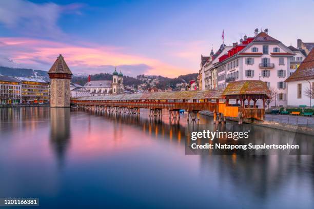 kapellbrucke over reuss river during morning golden hour in old town of lucerne, switzerland - luzern stock pictures, royalty-free photos & images