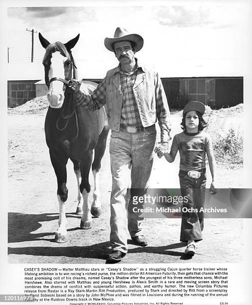 Walter Matthau and Michael Hershewe walk with colt in a scene from the film 'Casey's Shadow', 1978.