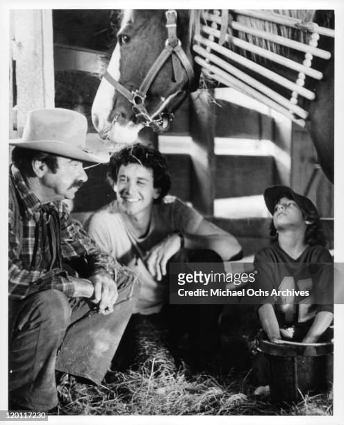 Walter Matthau, Andrew Rubin, Michael Hershewe sitting in barn with colt in a scene from the film 'Casey's Shadow', 1978.