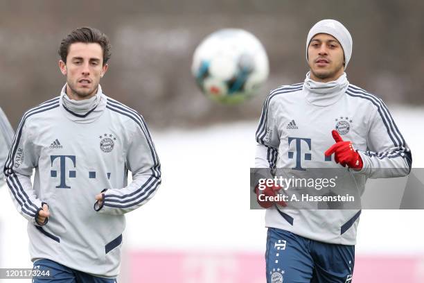 Alvaro Odriozola of FC Bayern Muenchen and his team mate Thiago Alcantara during a training session at Saebener Strasse training ground on January...