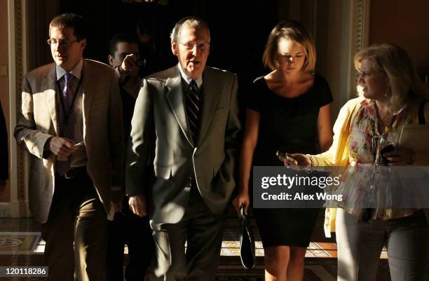 Senate Minority Leader Sen. Mitch McConnell is followed by members of the press as he returns to his office from the Senate Chamber July 30, 2011 at...