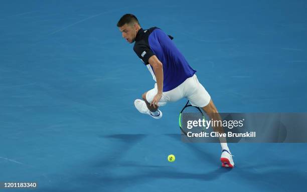 Filip Krajinovic of Serbia plays a shot between his legs during his Men's Singles second round match against Roger Federer of Switzerland on day...