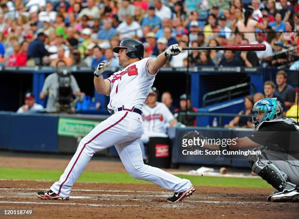 Dan Uggla of the Atlanta Braves hits a three run home run in the 4th inning against the Florida Marlins at Turner Field on July 30, 2011 in Atlanta,...