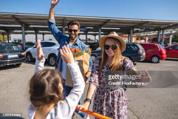excited family with daughter going to supermarket - man pushing cart fun play stock pictures, royalty-free photos & images