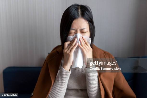 sick woman wiping her nose - handkerchief stock pictures, royalty-free photos & images