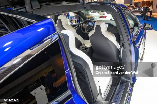 Open Falcon wing doors on a Tesla Model X 90D full electric luxury crossover SUV car on display at Brussels Expo on January 9, 2020 in Brussels,...