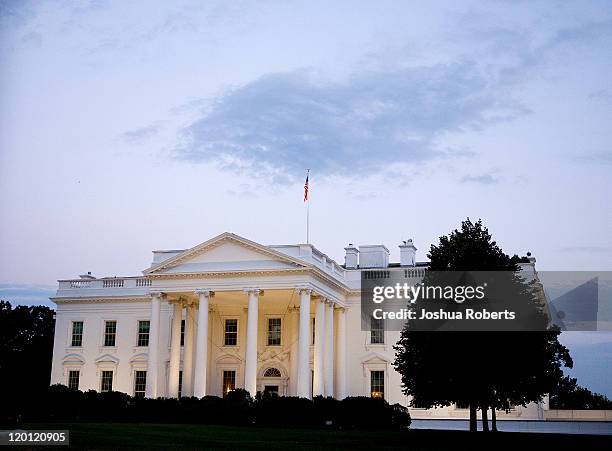 An American flag flies above the White House on the evening of July 30, 2011 in Washington, DC. Republican leaders held fresh talks with U.S....