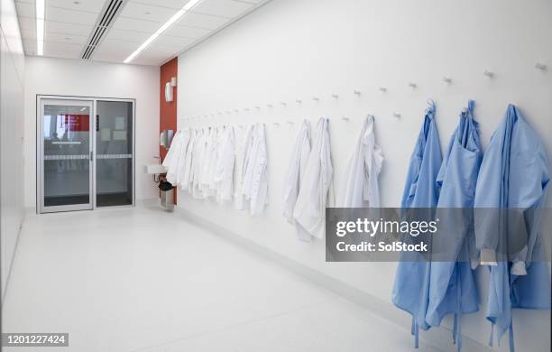 medical protective clothing - coat rack stock pictures, royalty-free photos & images