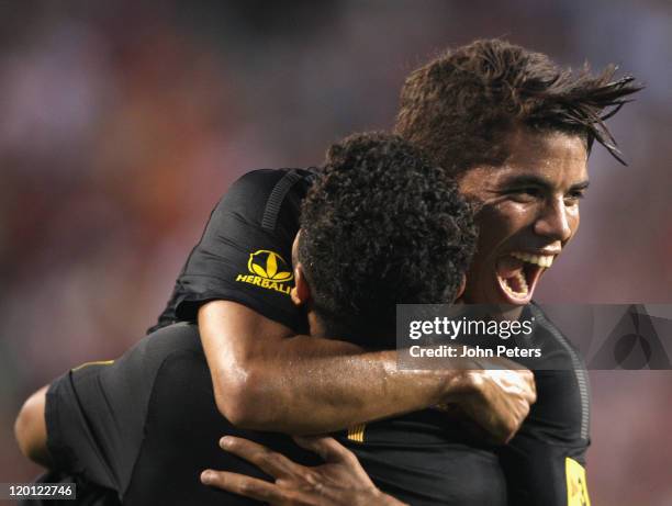 Thiago Alcantara of Barcelona celebrates scoring their first goal with Jonathan dos Santos during the pre-season friendly match between Manchester...