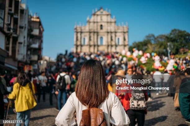 young woman traveler is visiting into ruins of st. paul's church in macau near hong kong in china - macao fotografías e imágenes de stock