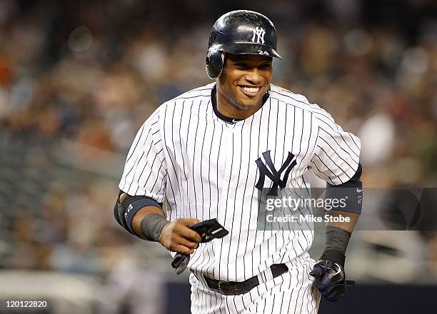 Robinson Cano of the New York Yankees smiles after he hits a double and drives in his fifth run of the game against the Baltimore Orioles on July 30,...