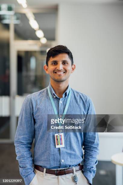 happy young man smiling at camera - id badge stock pictures, royalty-free photos & images