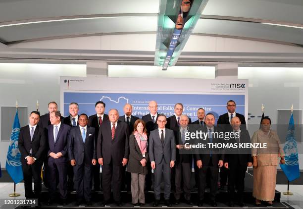 Members of the international committee pose for a family photo during a follow-up meeting on Libya, arranged by German Foreign Minister Heiko Maas ,...