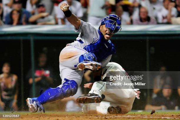 Lonnie Chisenhall of the Cleveland Indians is safe at home plate after after scoring against catcher Brayan Pena of the Kansas City Royals during the...
