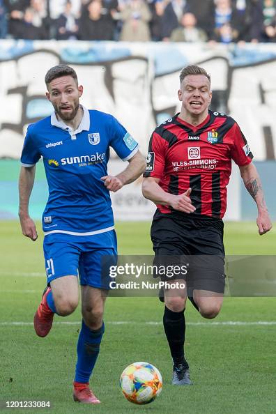 Rico Preißinger of Magdeburg battle for the ball against Lennard