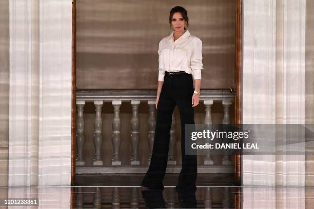 British fashion designer Victoria Beckham reacts after presenting creations for her Autumn/Winter 2020 collection on the third day of London Fashion...