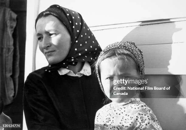 Portrait of a young Hutterite mother with her daughter, Northeast Alberta, Canada, 1963. Photo taken during the National Film Board of Canada's...