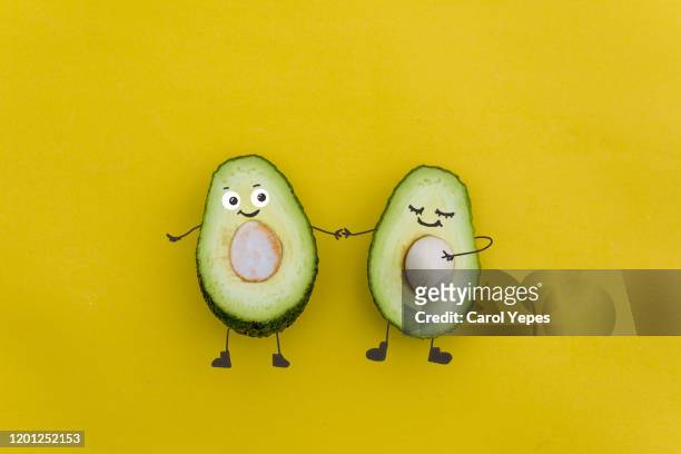 avocado pregnat couple in yellow - künstliche befruchtung unfruchtbarkeit stock-fotos und bilder