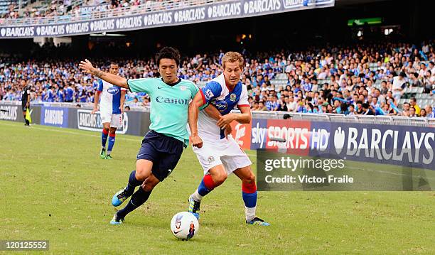 Morten Gamst Pedersen of Blackburn Rovers and Chu Siu Kei of Kitchee compete for the ball during the Asia Trophy pre-season friendly match at the...