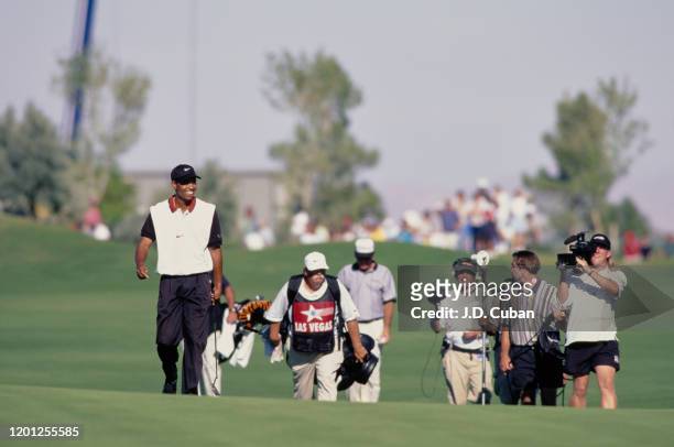 Tiger Woods of the United States walks down the 18th fairway on his way to his first professional golf tournament win at the PGA Las Vegas...