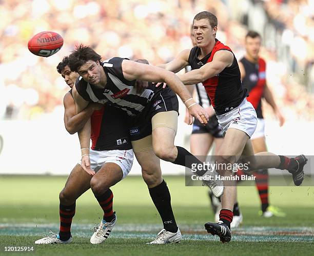Leigh Brown of the Magpies clears the ball from the pack during the round 19 AFL match between the Collingwood Magpies and the Essendon Bombers at...