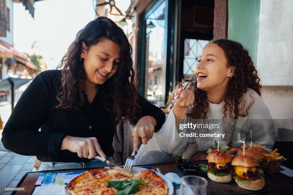 Young woman eating fast food
