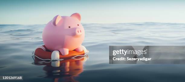 piggy bank on lifebuoy, 3d render - saving photos et images de collection