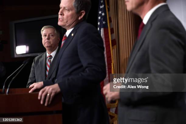 Sen. Steve Daines speaks as Sen. Lindsey Graham listens during a news conference on the Senate impeachment trial against President Donald Trump at...