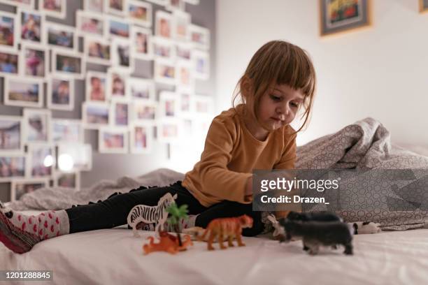 treårig flicka leker med plast djurleksaker - toy animal bildbanksfoton och bilder
