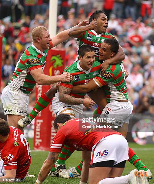 Michael Crocker, Nathan Peats and Chris Sandow of the Rabbitohs congratulate Dylan Farrell of the Rabbitohs after he scored a try during the round 21...