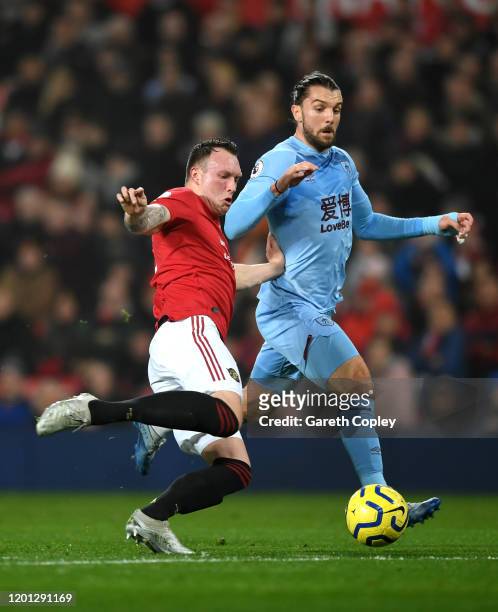 Phil Jones of Manchester United tackles Jay Rodriguez of Burnley during the Premier League match between Manchester United and Burnley FC at Old...