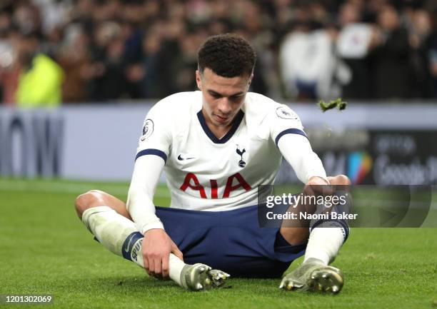 Dele Alli of Tottenham Hotspur picks grass out of his boots after the Premier League match between Tottenham Hotspur and Norwich City at Tottenham...