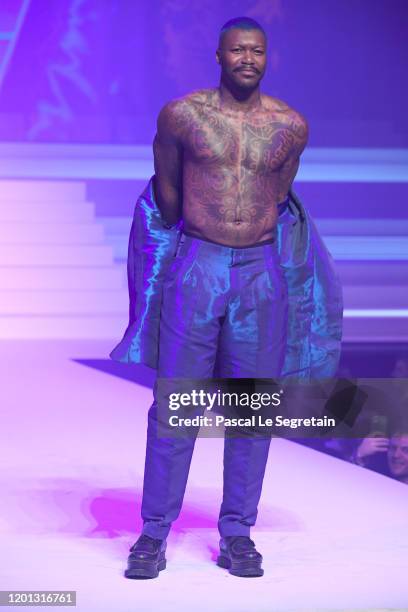 Djibril Cisse walks the runway during the Jean-Paul Gaultier Haute Couture Spring/Summer 2020 show as part of Paris Fashion Week at Theatre Du...