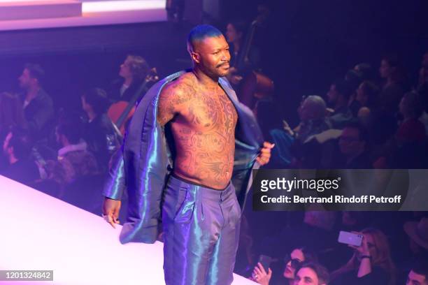 Djibril Cisse walks the runway during the Jean-Paul Gaultier Haute Couture Spring/Summer 2020 show as part of Paris Fashion Week at Theatre Du...